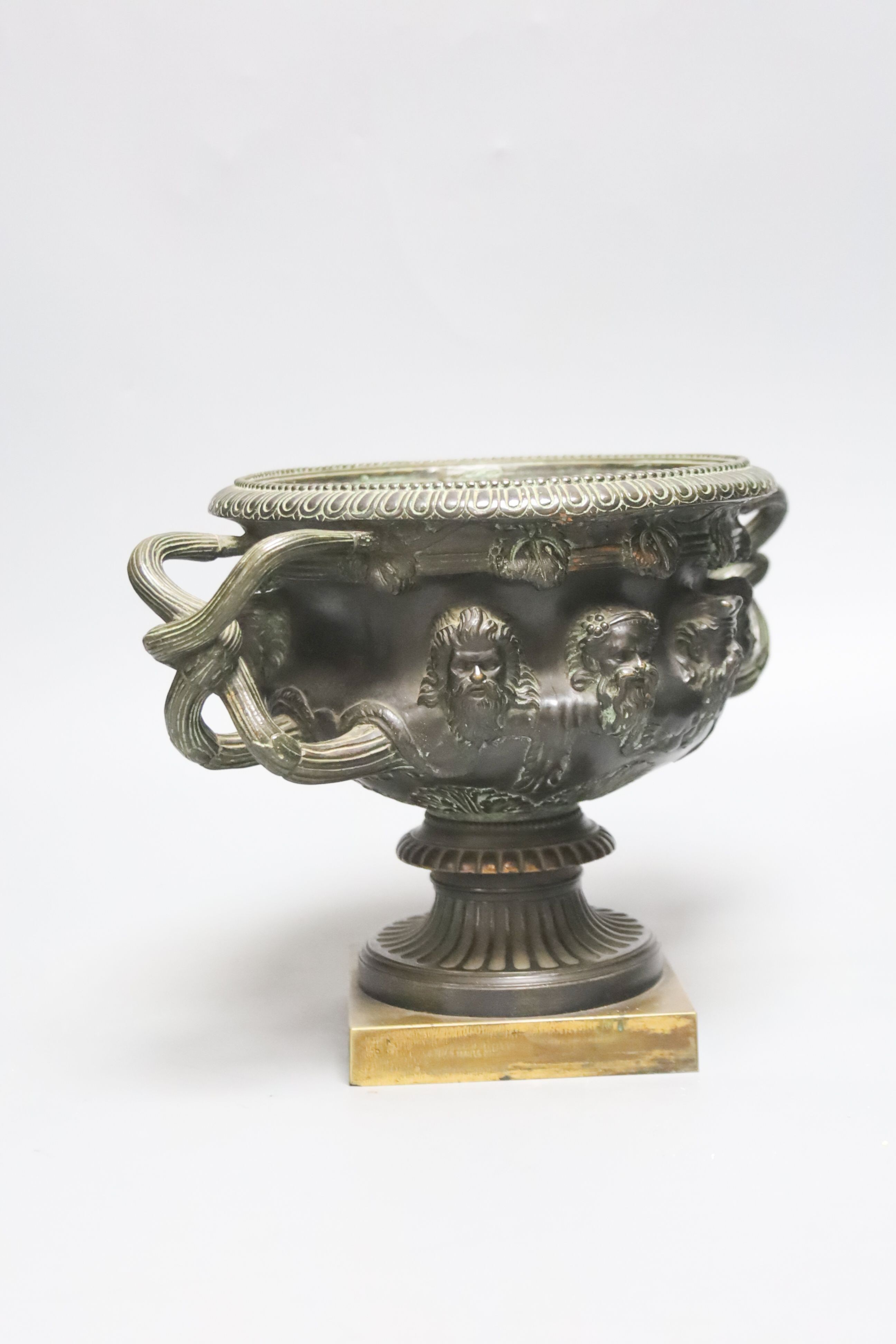 After the antique a bronze Warwick vase of typical form on square plinth foot. 19cm